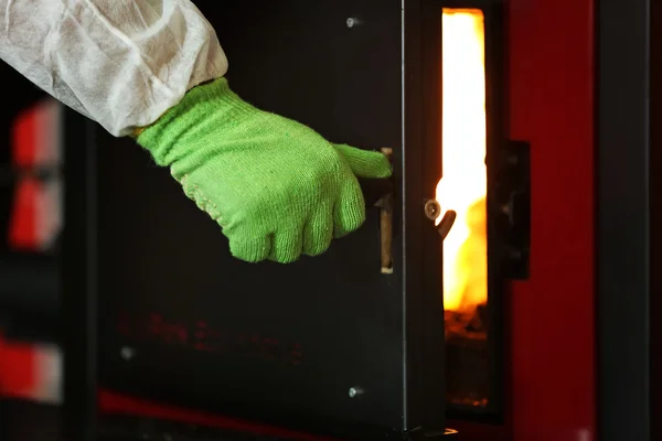 Hand opening boiler door — стоковое фото