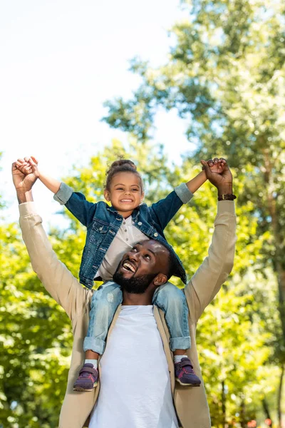 Happy African American Father Holding Daughter Shoulders Park — стоковое фото